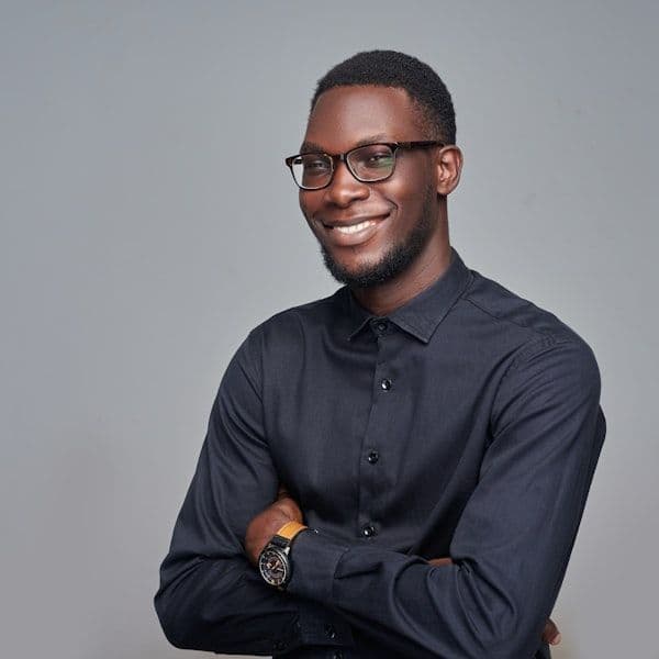man in black dress shirt wearing black framed eyeglasses